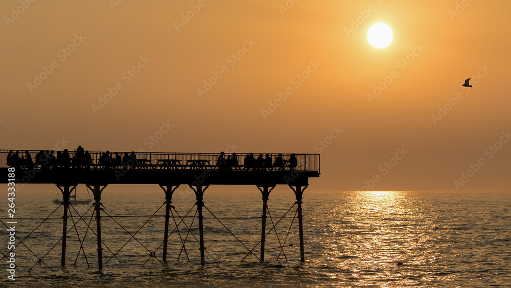 Aberystwyth Seafront on the coast to the Irish Sea with pier at sunset.