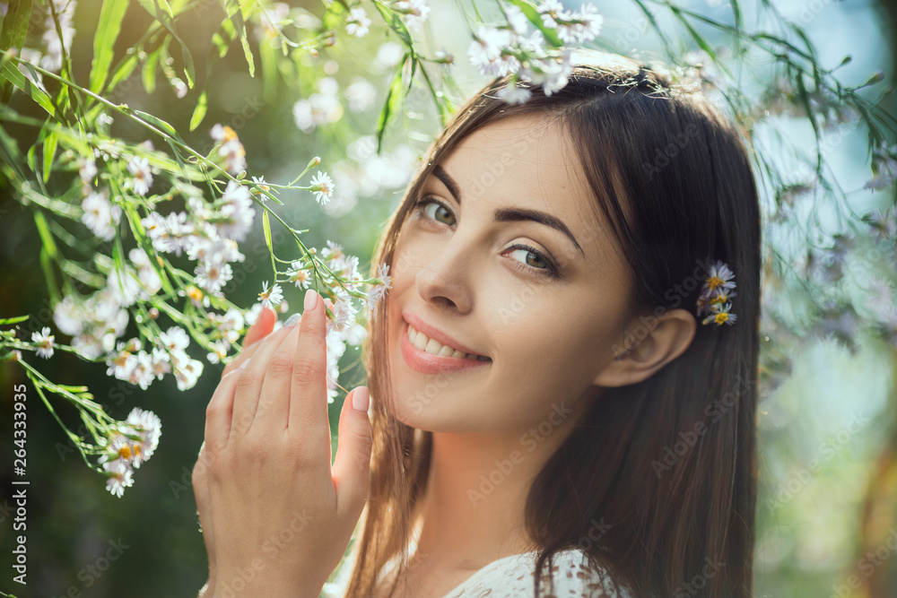 Beautiful young woman portrait in flower field Beautiful young woman portrait in flower field