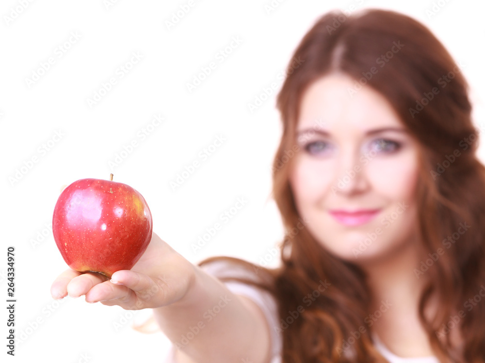 Woman holds red apple, focus on fruit Woman holds red apple, focus on fruit