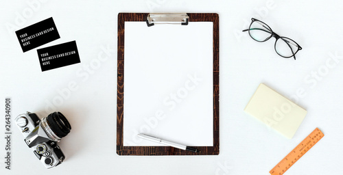 blank notebook with computer  smart phone  coffee and vintage camera on white wood background  business concept