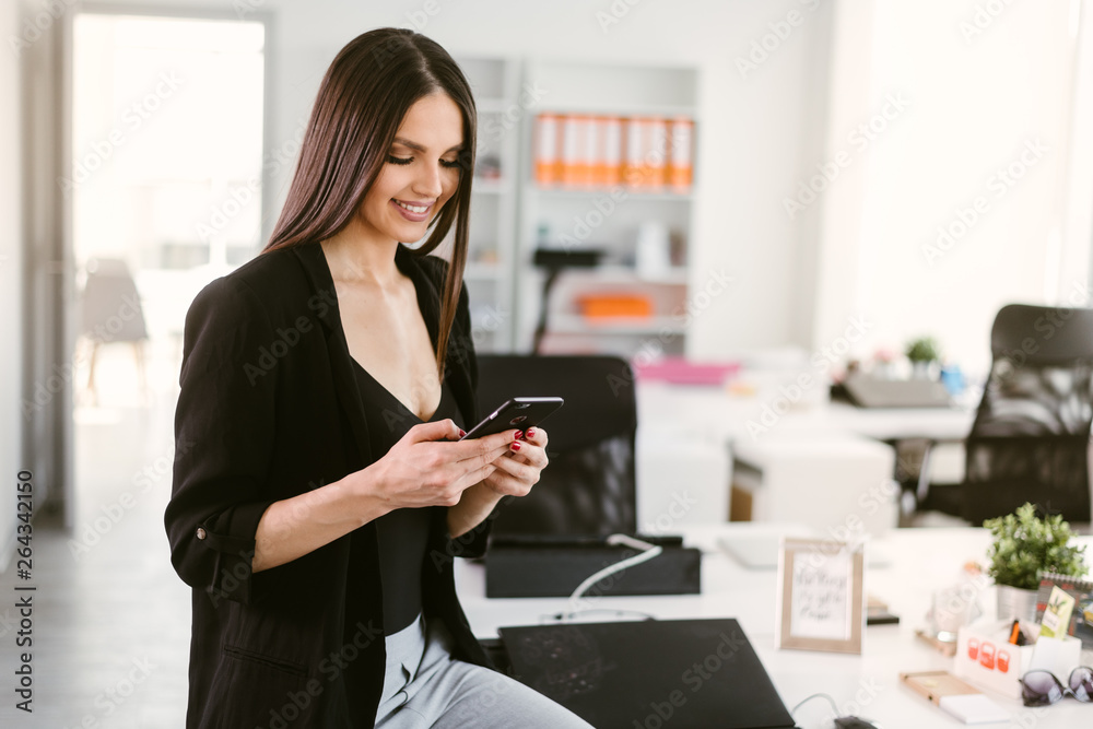 Manager on her phone. Female boss using her phone at the office. Employee on the phone. Manager on her phone. Female boss using her phone at the office. Employee on the phone.