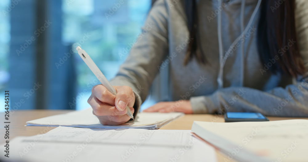 Woman study the note on paper at library Woman study the note on paper at library