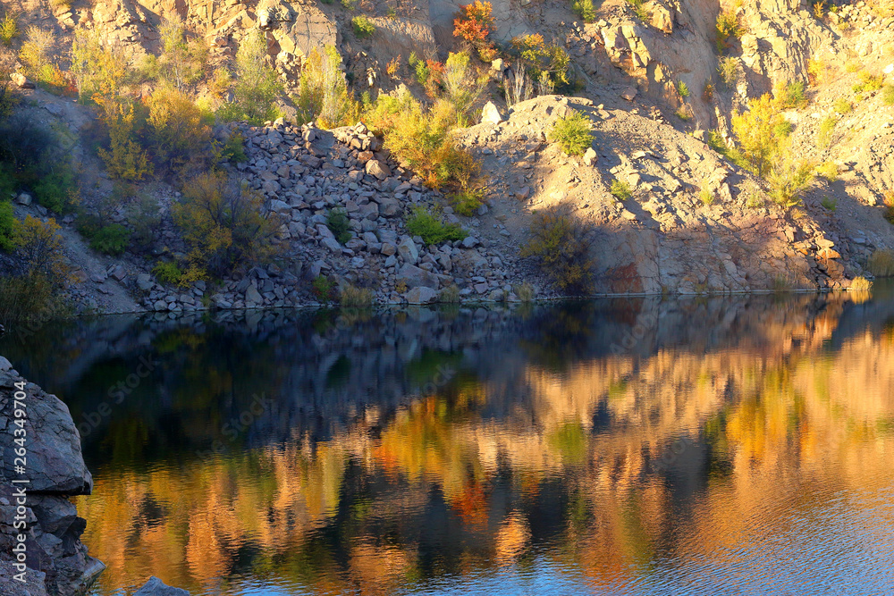 Radon Lake in former abandoned granite quarry full with pure transparent water at sunset. Ukraine, Migeia. Radon Lake in former abandoned granite quarry full with pure transparent water at sunset. Ukraine, Migeia.