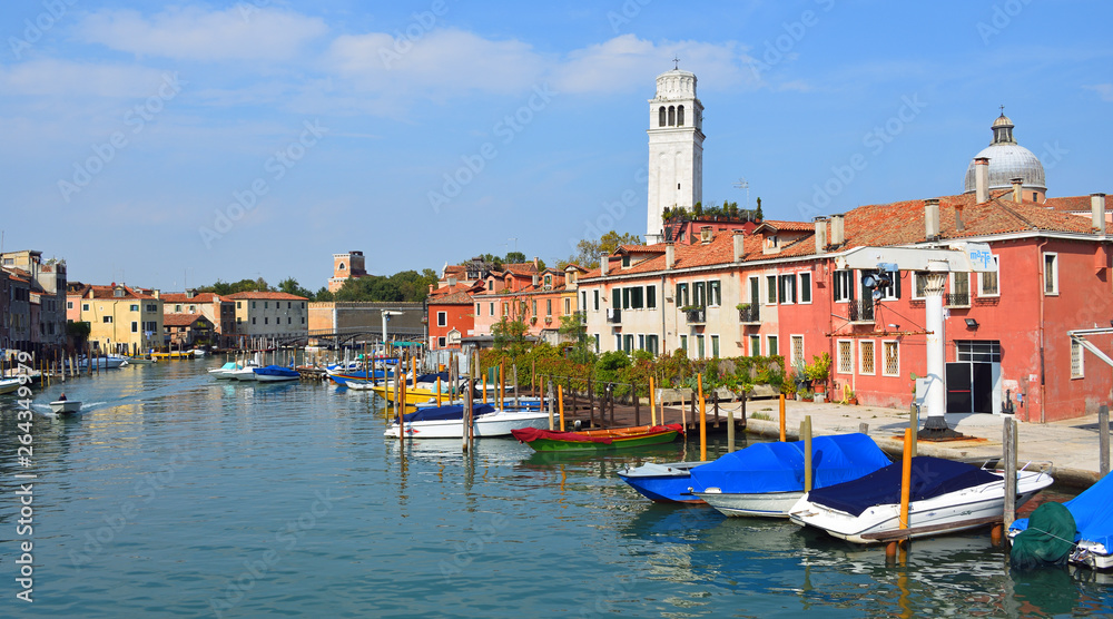 The Island of San Pietro with its curious leaning  Tower and view of Arsenale wall , Venice.