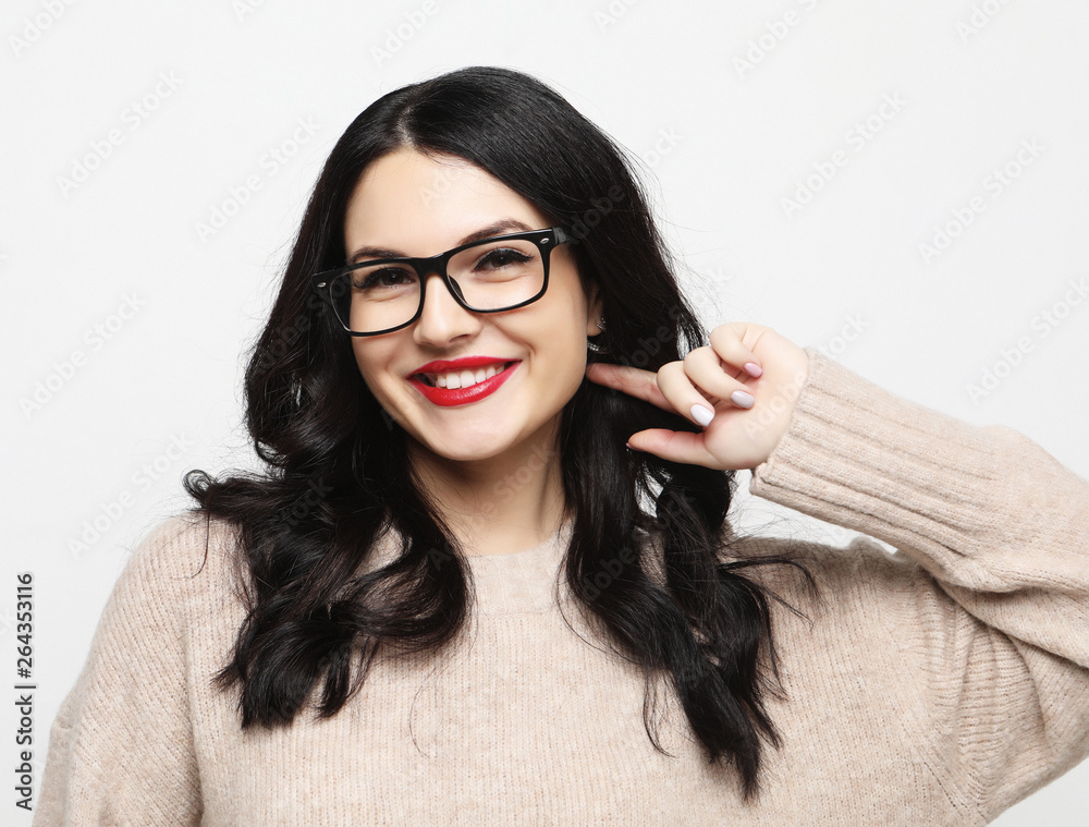 young positive female with cheerful expression, dressed in casual clothes with eyeglasses, over white background. Lifestyle concept. young positive female with cheerful expression, dressed in casual clothes with eyeglasses, over white background. Lifestyle concept.