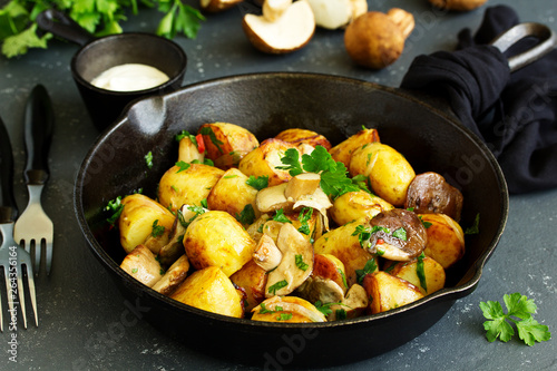 Baked potatoes with mushrooms in a frying pan.