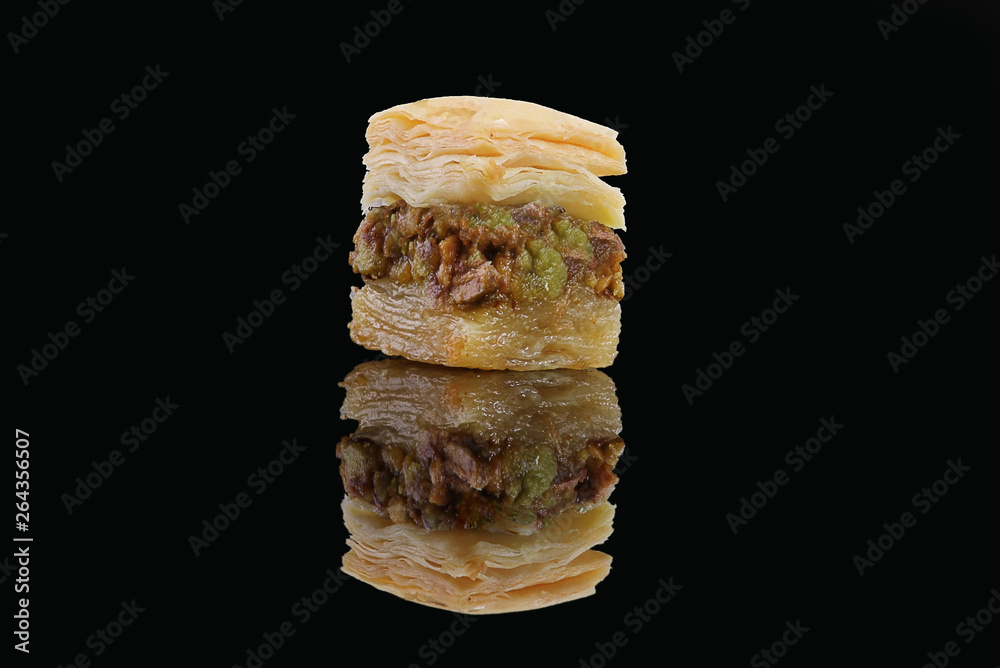 Middle eastern, Turkish sweet pastry baklava isolated on black background Middle eastern, Turkish sweet pastry baklava isolated on black background