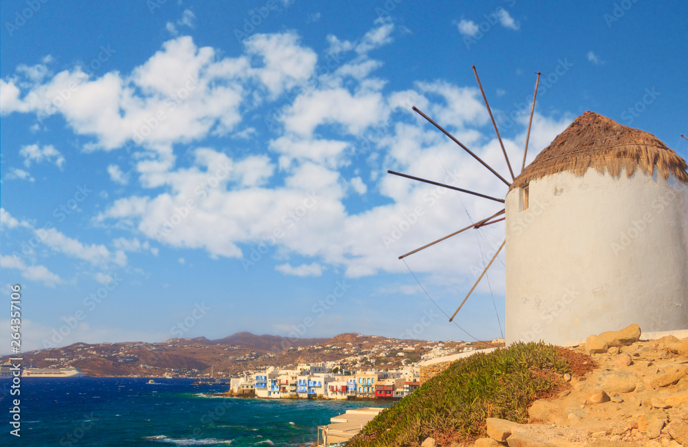 White famous windmills overlooking Little Venice and Mykonos old town, Mykonos, Cyclades, Greece.	