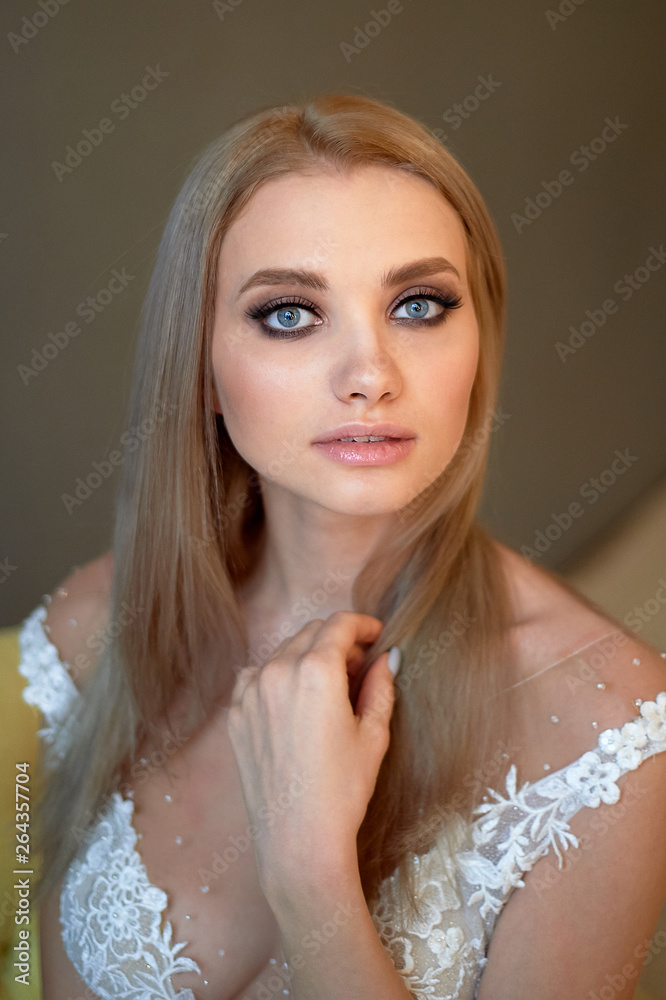 Portrait of a beautiful bride in a lace dress. Makeup smoky eyes, emphasis on eyes. Long flowing hair.