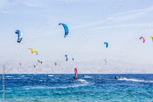 Wind surfers sea activities concept photography near coral beach in Eilat city in south Israeli waterfront of the Red sea scenic landscape place blue environment