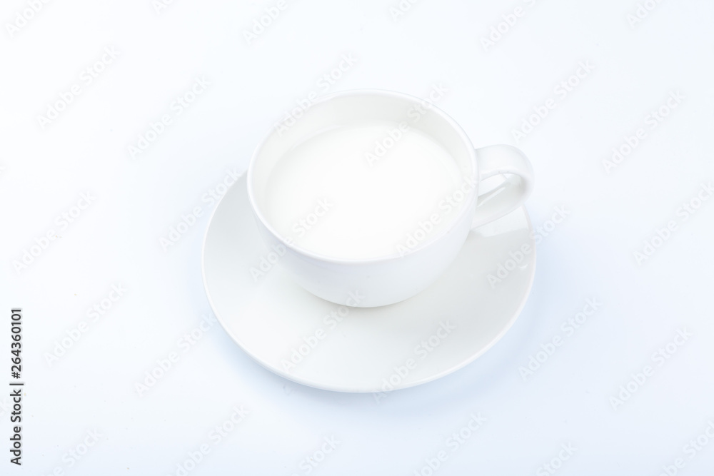 A glass of white milk on a white background