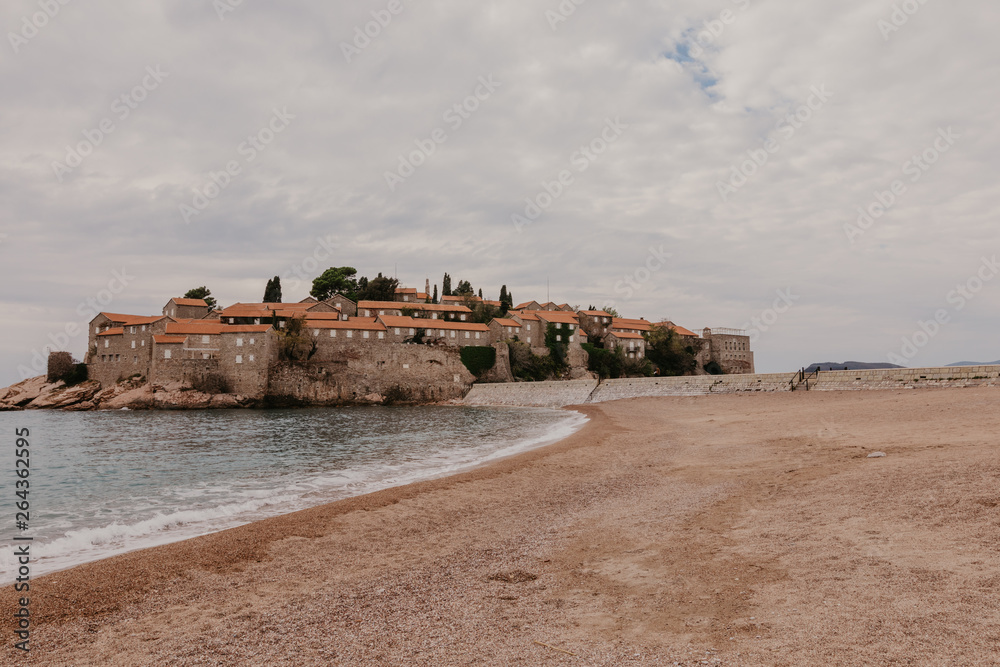 Sveti Stefan historical town island and paradise sand beach. Budva, Montenegro