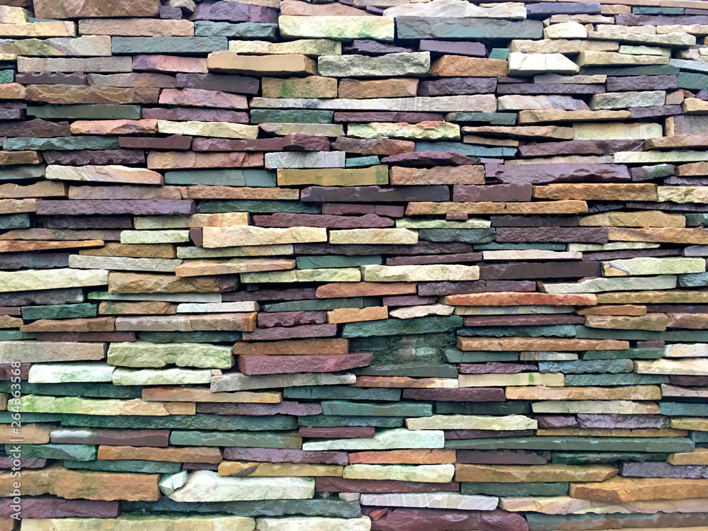 Colorful stone tile construction surface background.