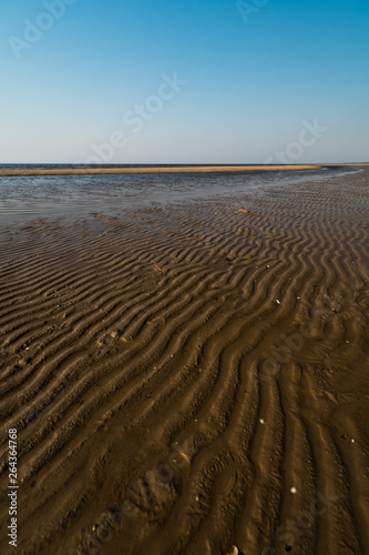 Dessert like textured sand - Baltic sea gulf beach with white sand in the sunset