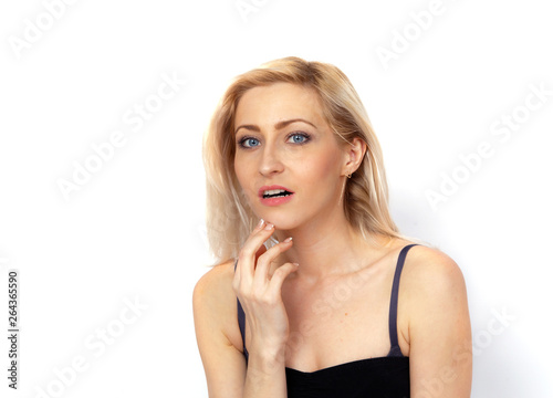 Portrait of a young woman listening to something carefully against a white background