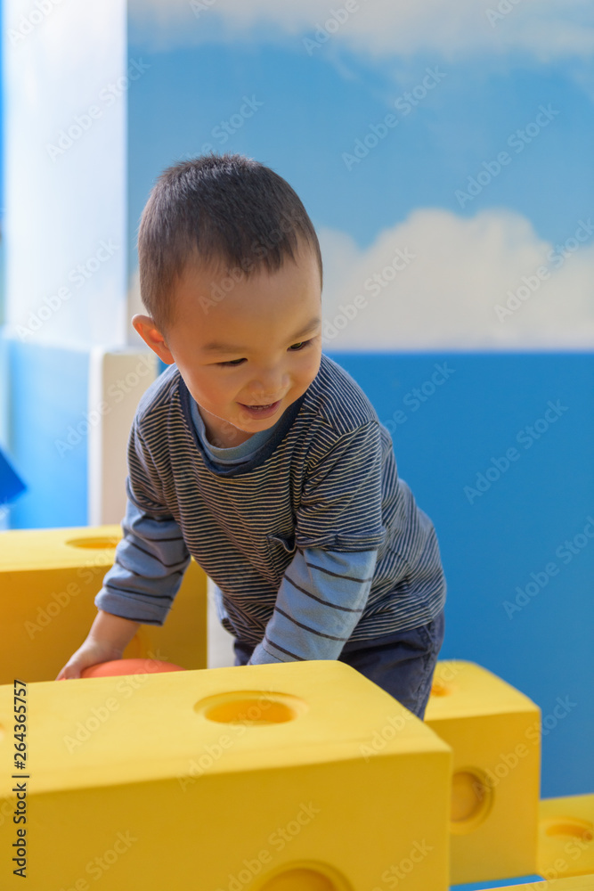 Asian baby boy in indoor playground Asian baby boy in indoor playground
