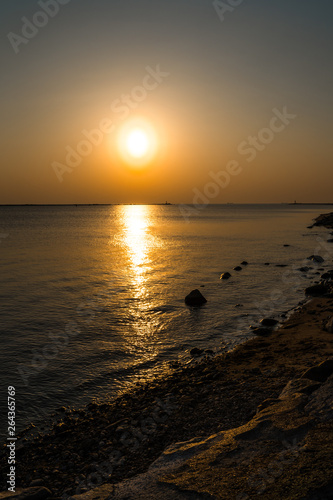 Boulder beach sunset with clear sky and beautiful vivid warm colors