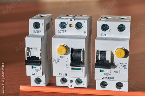 Quadro su tela Electric circuit breaker, protective shutdown device, differential current circuit breaker lie in a row on the table