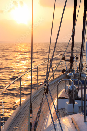 Fototapeta Naklejka Na Ścianę i Meble -  Yacht sailing towards the sunset