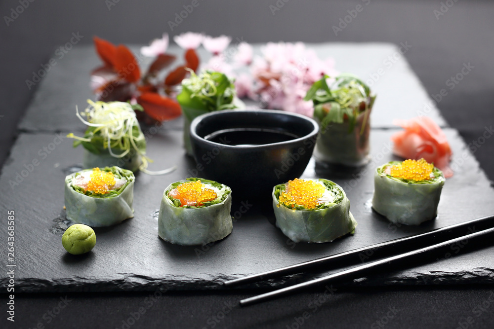 Spring sushi, sushi rolls with salmon, rucola, philadelphia cheese.