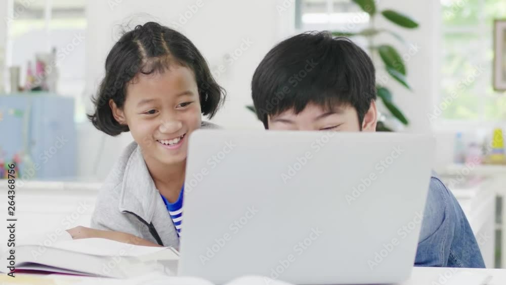 Young boys are using computers to teach and explain homework. To friends with facial expressions and happy gestures, Dolly shot 60fps. Young boys are using computers to teach and explain homework. To friends with facial expressions and happy gestures, Dolly shot 60fps.