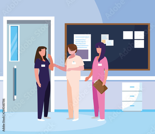 group medicine workers with uniform in hospital corridor © djvstock