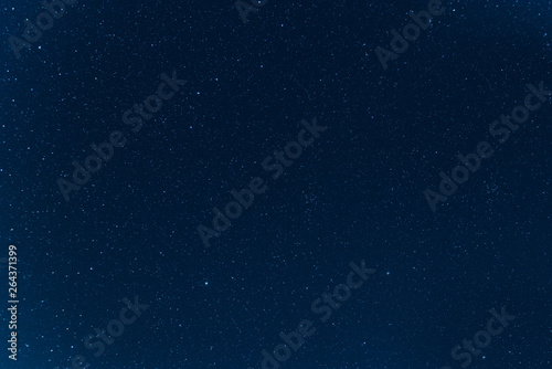 Night blue sky with stars. The texture of a blue sky with stars.