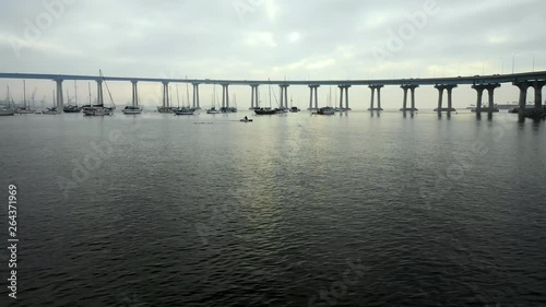 Wallpaper Mural Aerial Forward: Boats Floating In Ocean Water Under Bridge On Cloudy Day in San Diego, United States of America Torontodigital.ca