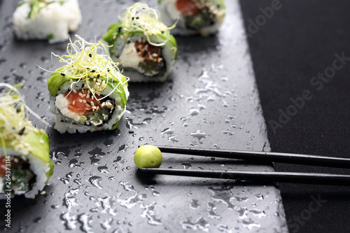 Sushi. Sushi roll with salmon, cucumber, cheese, kampyo and avocado slices. photo
