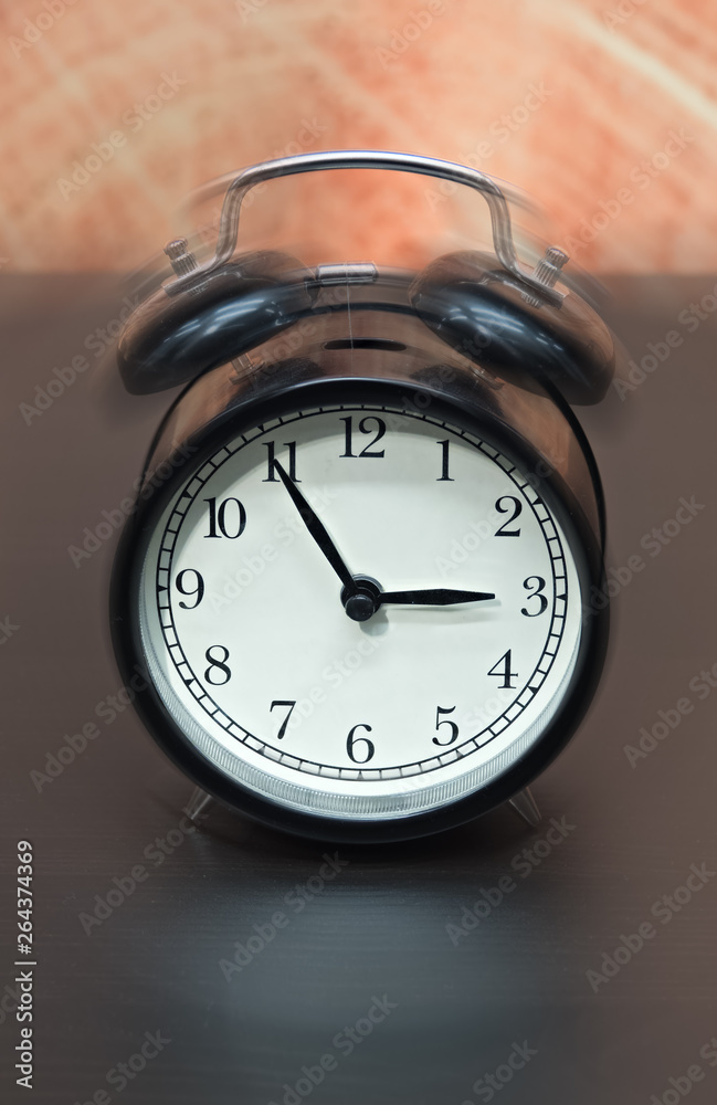 Old fashioned black alarm clock vibrating Old fashioned black alarm clock vibrating