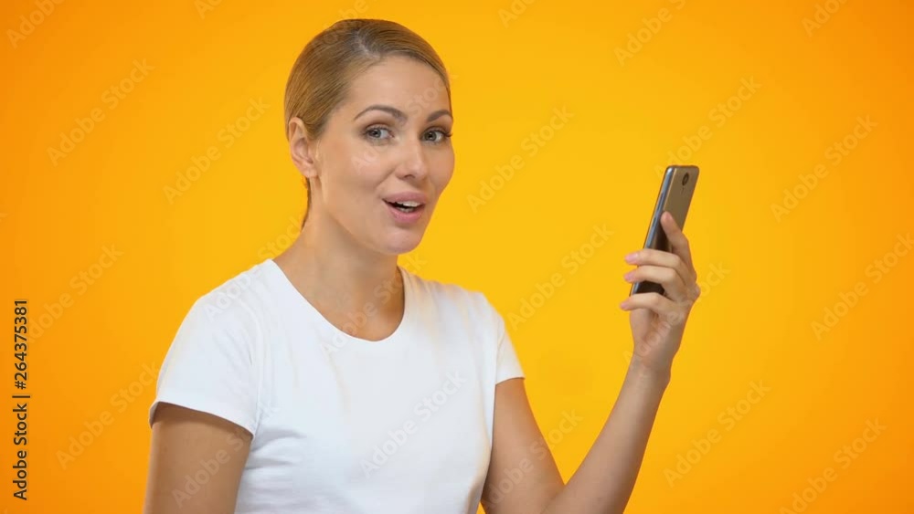 Happy woman using smartphone application, surprised by online shopping discount Happy woman using smartphone application, surprised by online shopping discount
