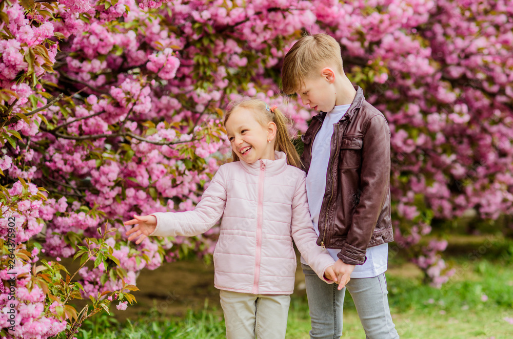 Tender love feelings. Little girl and boy. Romantic date in park