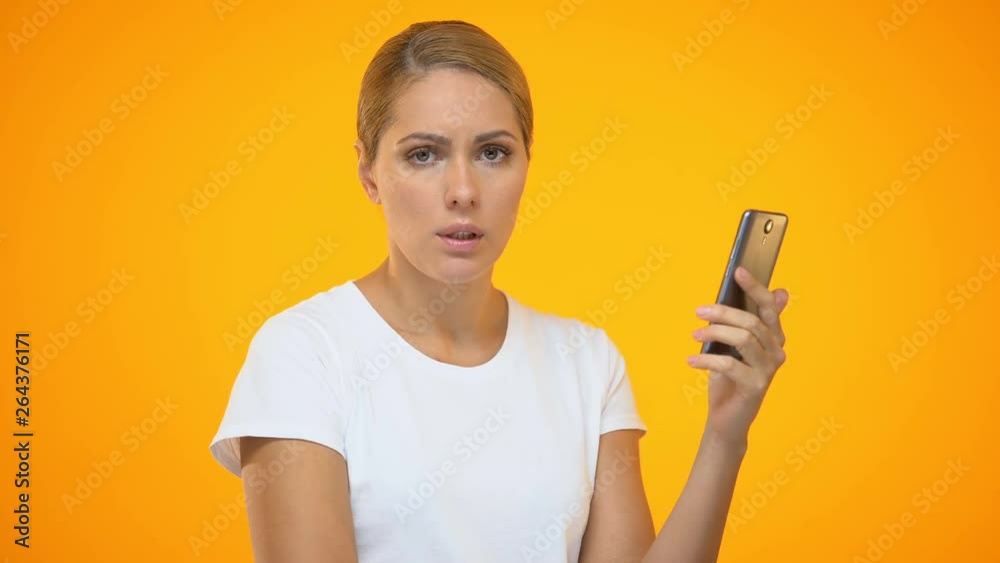 Annoyed lady scrolling smartphone photo, bad online connection, mobile tariff