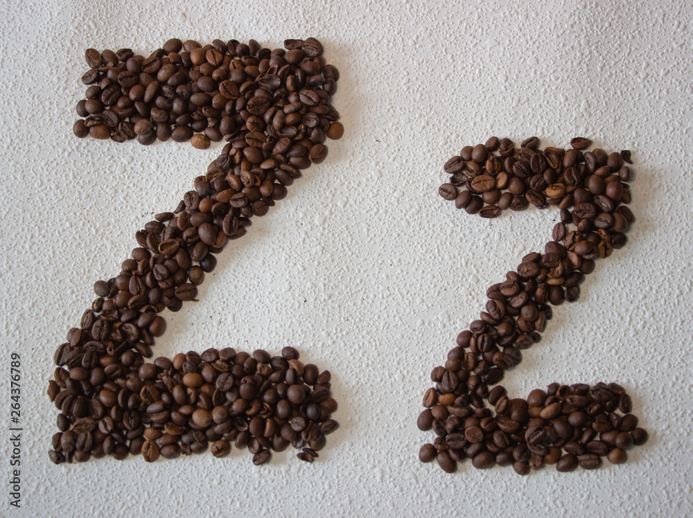 Image of roasted coffee beans shaped alphabet on a white background Image of roasted coffee beans shaped alphabet on a white background