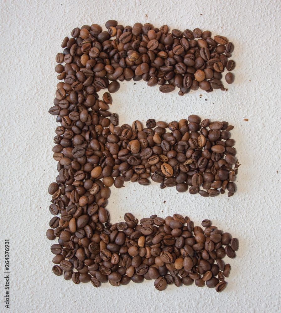 Image of roasted coffee beans shaped alphabet on a white background Image of roasted coffee beans shaped alphabet on a white background