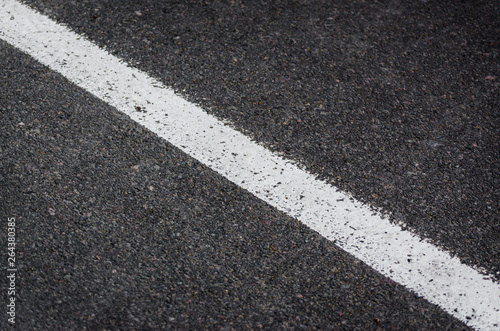 white streak of paint on gray asphalt