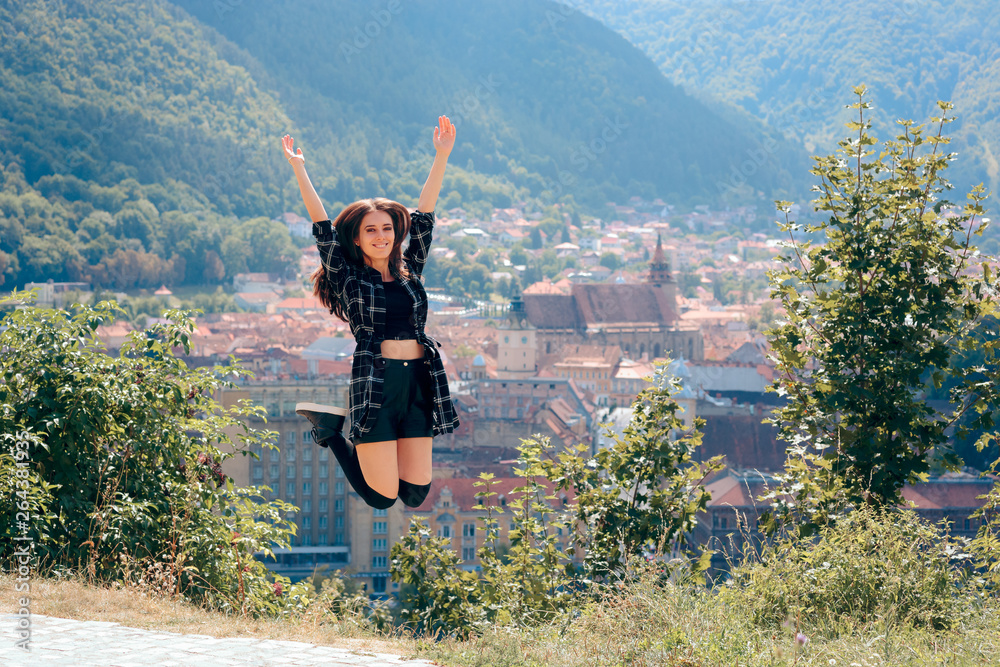 Fototapeta premium Happy Tourist Jumping in Front of Panoramic City View