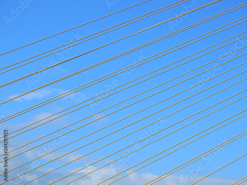 yellow wire rope sling of bridge with blue sky background