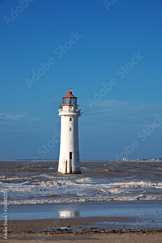 Fort Perch Lighthouse in New Brighton Merseyside on a sunny early spring day at low tide.