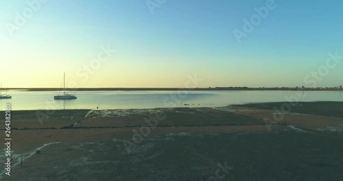 Sunrise aerial seascape, in Ria Formosa wetlands natural park, shot at Cavacos beach. Algarve. Portugal.