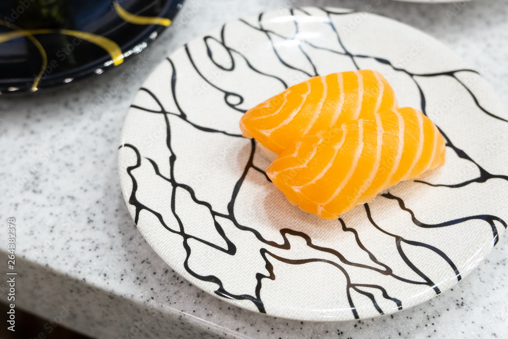 Japanese cuisine,Salmon sushi on white plate.