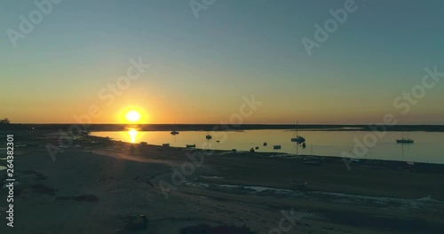 Sunrise aerial seascape, in Ria Formosa wetlands natural park, shot at Cavacos beach. Algarve. Portugal.