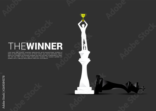Silhouette of businessman standing on winner chess to checkmate. concept of winner in business and marketing strategy