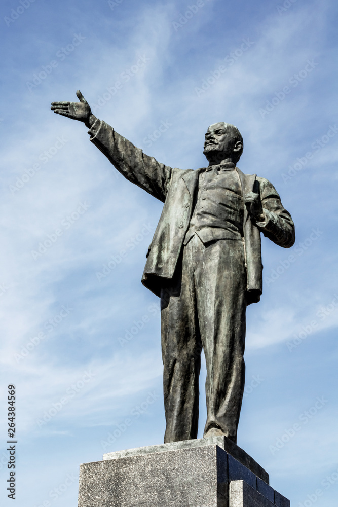 UFA, RUSSIA - 7 APRIL 2019: Sculpture of Vladimir Ilyich Lenin in the town square against the sky. Concept for printing leaflets, cards, editorial photo