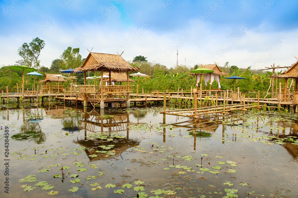Summer in public park. Pavilion in the middle of pond. Bamboo pavilion, rural scenery in thailand