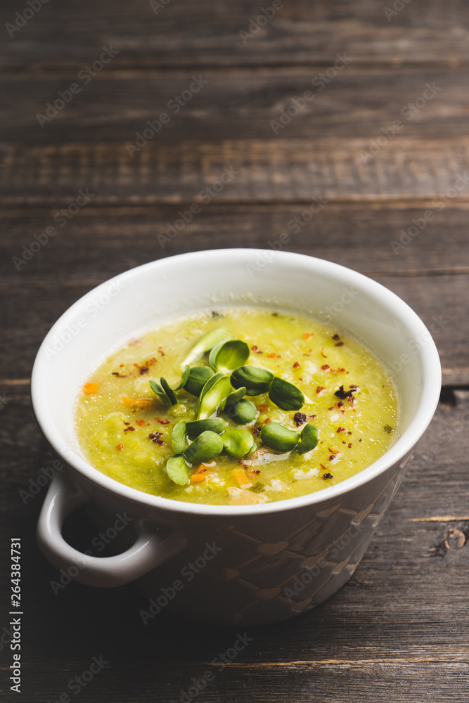 Hot green peas soup on the rustic background. Selective focus. Shallow depth of field.