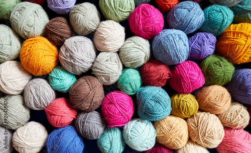 Colorful background made of wool yarn balls.
