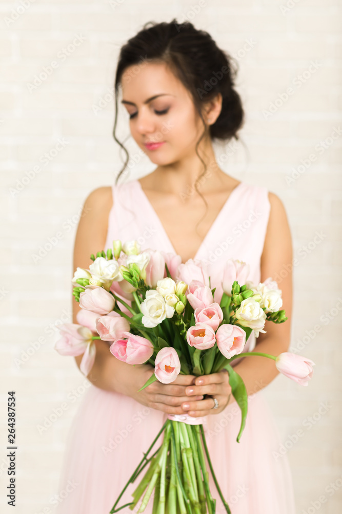 Portrait of beautiful bride with wedding bouquet of pink tulips Portrait of beautiful bride with wedding bouquet of pink tulips