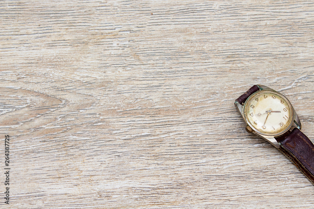 watch man on wooden table watch man on wooden table