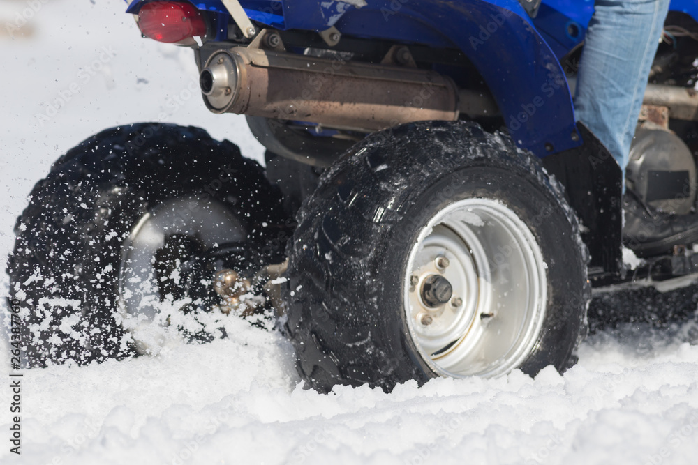 A bright blue snowmobile in the forest in the snow A bright blue snowmobile in the forest in the snow